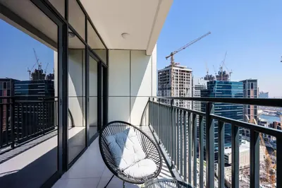 a balcony with a chair and a view of the city at Canalfront Gem 1BR in Zada Tower by Livbnb in Dubai