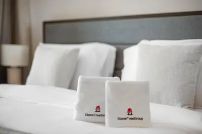 a bed with white towels on top of it at Modern 2-Bedroom Apartment in Aykon Tower C in Dubai
