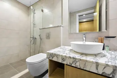 a white bathroom with a sink and a toilet at Modern 2-Bedroom Apartment in Aykon Tower C in Dubai