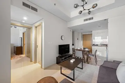 a living room with a couch and a table at Modern 2-Bedroom Apartment in Aykon Tower C in Dubai