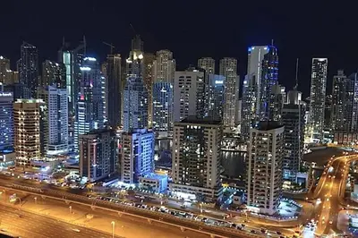 a night view of a large city with buildings at Fabulous Studio in JLT with Lake View in Dubai