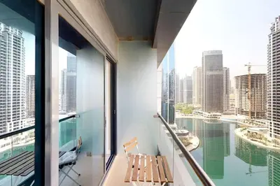 a balcony with a chair and a view of the city at Fabulous Studio in JLT with Lake View in Dubai