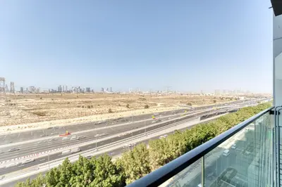 a view of a highway from a building at Stylish Studio with Pool, Gym & Tasteful Decor in Dubai