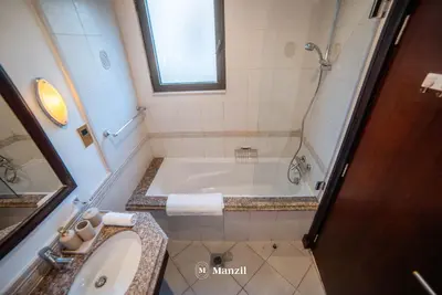 a bathroom with a tub and a sink at Lux 5BR Villa with Pool & Beach Access in Palm Jumeirah in Dubai