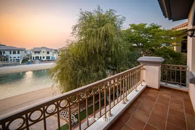 a balcony with a view of the water at Lux 5BR Villa with Pool & Beach Access in Palm Jumeirah in Dubai