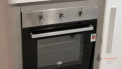 a black oven with a glass door at PREMIER STUDIO I Poolside in Dubai