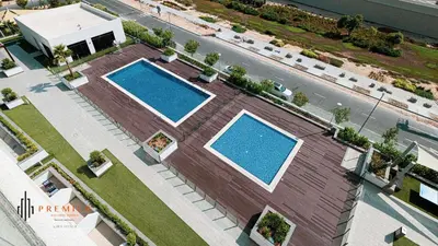 an overhead view of two swimming pools on a building at PREMIER STUDIO I Poolside in Dubai