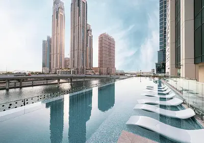 a pool of water in a city with tall buildings at Brand new Studio in Business Bay, Missoni Tower in Dubai