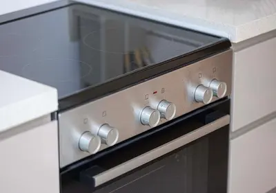 a kitchen with a stove with a window on it at Brand new Studio in Business Bay, Missoni Tower in Dubai