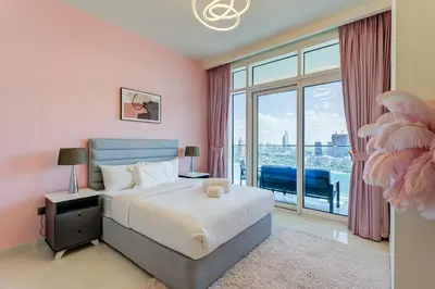 a bedroom with a bed and a large window at Private Beachfront 2 Bed With 180 Marina Skyline in Dubai