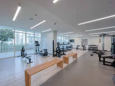 a gym with treadmills and benches and exercise equipment at Private Beachfront 2 Bed With 180 Marina Skyline in Dubai