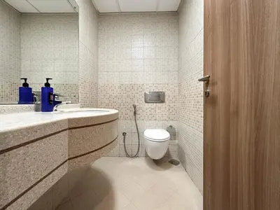 a bathroom with a toilet and a sink at Trophy Starlight Suites Lux Upgraded 1BR in Marina in Dubai