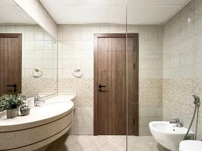 a bathroom with two sinks and a glass door at Trophy Starlight Suites Lux Upgraded 1BR in Marina in Dubai