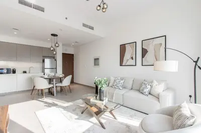 a living room with a couch and a table at Livbnb - Stylish 1B in Park Heights Dubai Hills in Dubai