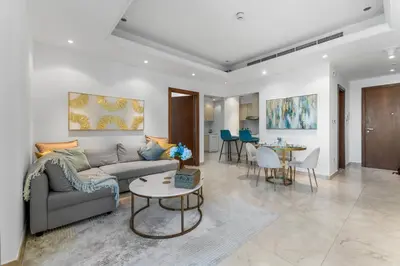 a living room with a couch and a table at Elegant One Bed Apartment - Panoramic Marina Views - Near JBR & Beach in Dubai