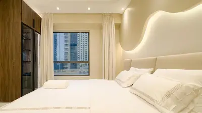 a bedroom with a large white bed with a window at Usmans 4 Bedroom Apartment on D Beach By SLS DIRECT BEACH ACCESS FULLY SERVICED JBR in Dubai