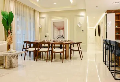 a dining room with a wooden table and chairs at Usmans 4 Bedroom Apartment on D Beach By SLS DIRECT BEACH ACCESS FULLY SERVICED JBR in Dubai