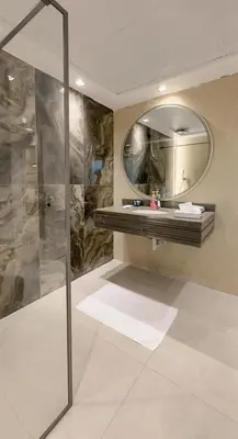 a bathroom with a shower and a mirror at Usmans 4 Bedroom Apartment on D Beach By SLS DIRECT BEACH ACCESS FULLY SERVICED JBR in Dubai