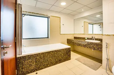 a bathroom with a tub and a sink at Bright apartment in JBR few steps from the beach in Dubai