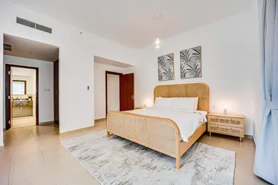 a bedroom with a large bed in a room at Bright apartment in JBR few steps from the beach in Dubai