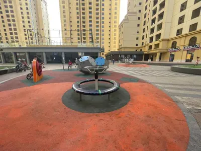 a sculpture in the middle of a city with buildings at Bright apartment in JBR few steps from the beach in Dubai