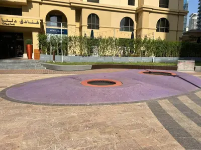 a purple circle in front of a building at Bright apartment in JBR few steps from the beach in Dubai