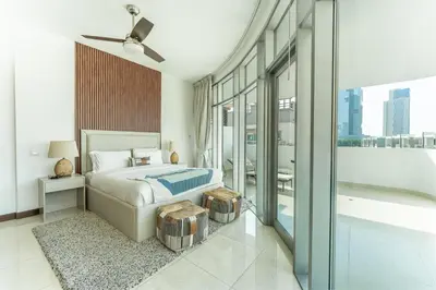 a bedroom with a bed and a large window at HAVN - 1 Bedroom Apartment in Villa Pera, JVC in Dubai