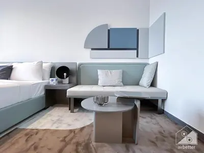 a living room with a couch and a table at Modern Meydan Studio with Private Balcony in Dubai
