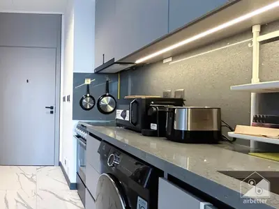 a kitchen with a stove and a counter top at Modern Meydan Studio with Private Balcony in Dubai