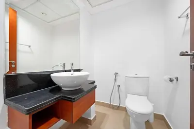a bathroom with a sink and a toilet at Chic 1BR APT with Pool, Gym, BBQ, Tennis Court in Dubai