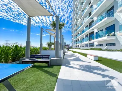 a view of a building with tables and benches at Balcony Studio Haven in Riviera in Dubai