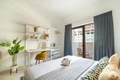 a bedroom with a bed and a desk with a computer at Frank Porter - G24 Tower in Dubai