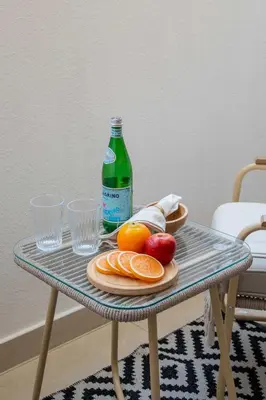 a table with a bottle of soda and fruit on it at Frank Porter - G24 Tower in Dubai