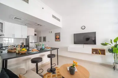 a kitchen and living room with a table and chairs at Frank Porter - G24 Tower in Dubai