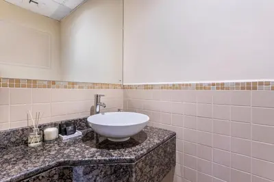 a bathroom with a white sink on a counter at 2 Bedroom Apartment at Bahar 1 JBR by TSHH in Dubai