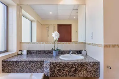 a bathroom with a sink and a mirror at 2 Bedroom Apartment at Bahar 1 JBR by TSHH in Dubai