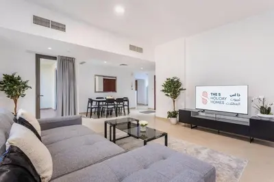 a living room with a couch and a tv at 2 Bedroom Apartment at Bahar 1 JBR by TSHH in Dubai