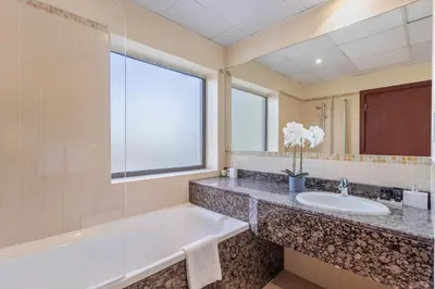 a bathroom with a tub and a sink at 2 Bedroom Apartment at Bahar 1 JBR by TSHH in Dubai