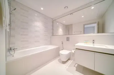 a bathroom with a tub and a toilet and a sink at New 2 bedroom full sea view in Dubai