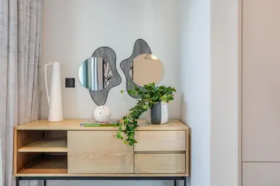 a dressing table with two mirrors on the wall at STAY BY LATINEM Luxury 2BR Holiday Home W205 near Burj Khalifa in Dubai