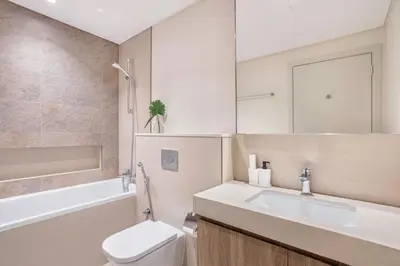 a bathroom with a sink and a toilet and a mirror at Clse Elegance Redefined Luxury 1 Bedroom Apartment with Premium Facilities in Dubai