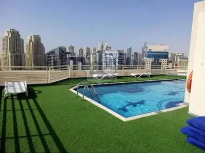 a large swimming pool on the roof of a building at Brand New and Stylish Interior in Dubai