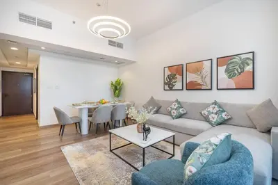 a living room with a couch and a table at Vogue Al Fahad Tower, Al Barsha Heights near Mall of The Emirates, Walking Distance to DIC Metro Station, Two Bedroom Apartment with Balcony and Access to all Amenities in Dubai