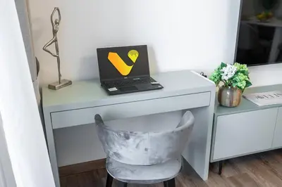 a desk with a laptop computer on top of it at Vogue Al Fahad Tower, Al Barsha Heights near Mall of The Emirates, Walking Distance to DIC Metro Station, Two Bedroom Apartment with Balcony and Access to all Amenities in Dubai