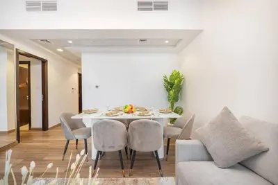 a dining room with a table and chairs at Vogue Al Fahad Tower, Al Barsha Heights near Mall of The Emirates, Walking Distance to DIC Metro Station, Two Bedroom Apartment with Balcony and Access to all Amenities in Dubai