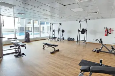 a gym with several treadmills and machines in a room at Vogue Al Fahad Tower, Al Barsha Heights near Mall of The Emirates, Walking Distance to DIC Metro Station, Two Bedroom Apartment with Balcony and Access to all Amenities in Dubai