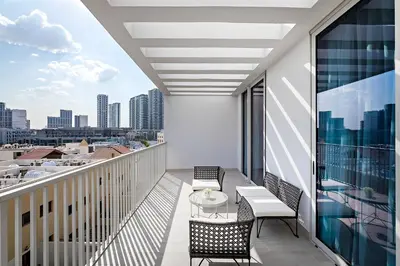 a balcony with a table and chairs and a view of the city at Bright 1BR with balcony in Luma 22 in Dubai