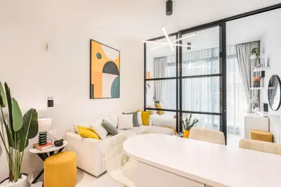 a living room with white furniture and yellow accents at Stylish Contemporary Home in JVC with Chic Interior in Dubai
