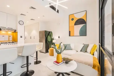 a living room with a couch and a table at Stylish Contemporary Home in JVC with Chic Interior in Dubai