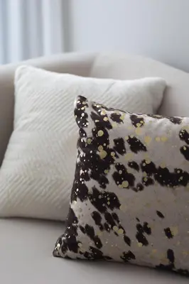 a leopard print pillow sitting on a couch at Modern and Cozy 1BR in Business Bay in Dubai